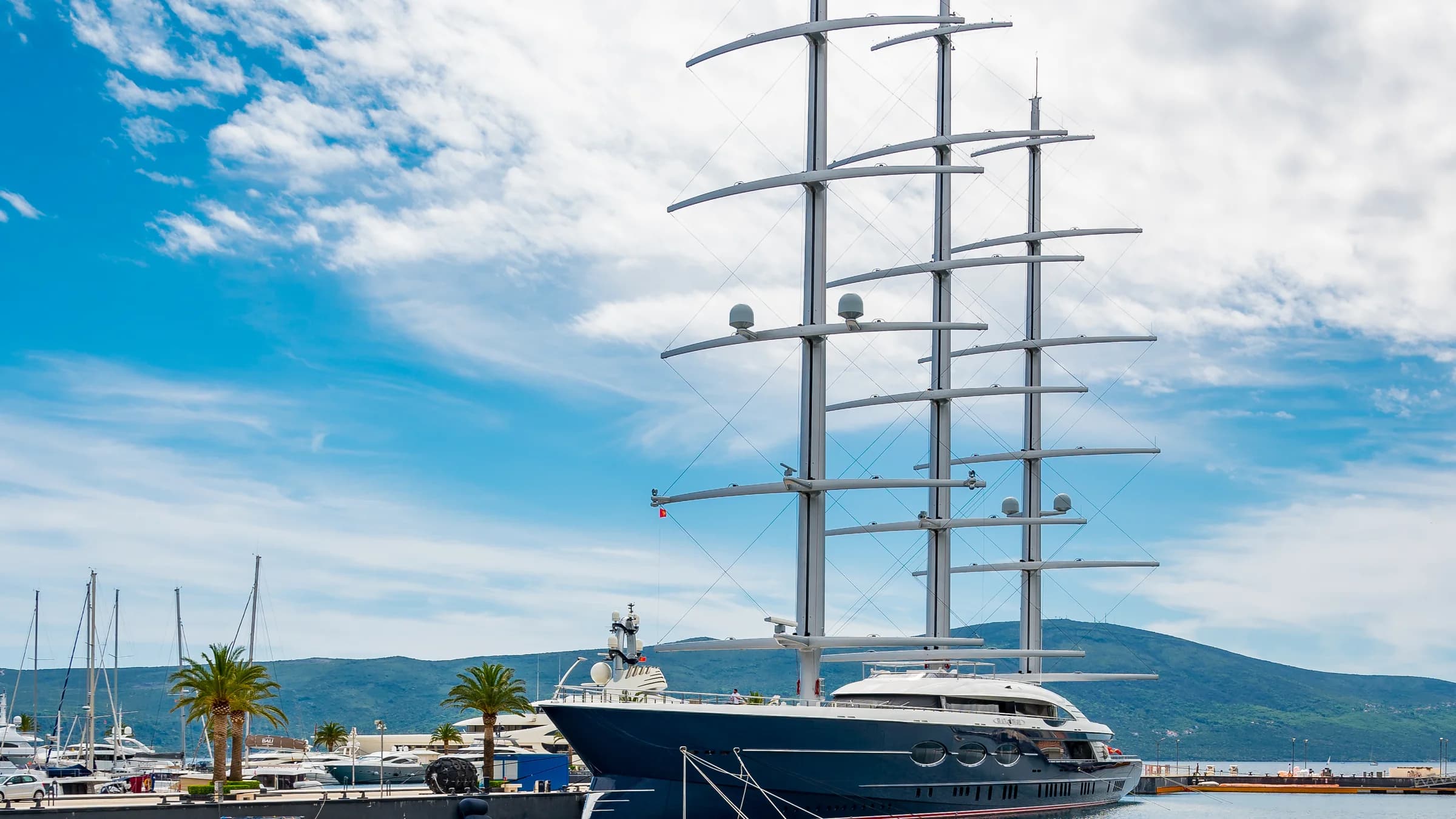 A tall ship moored at a marina in Tivat